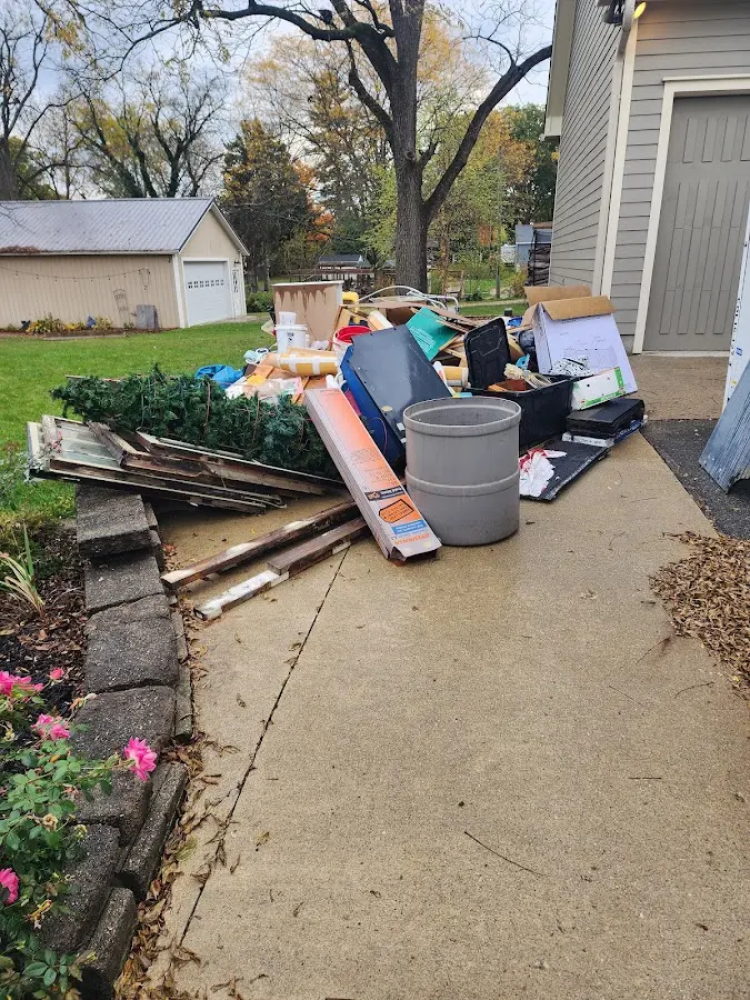 Dumpster being loaded with debris for 3 Yard Dumpster Rental in Girard